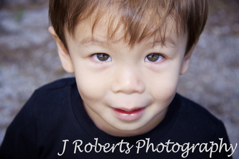 Toddler looking straight up at the camera with clear eyes - family portrait photography sydney